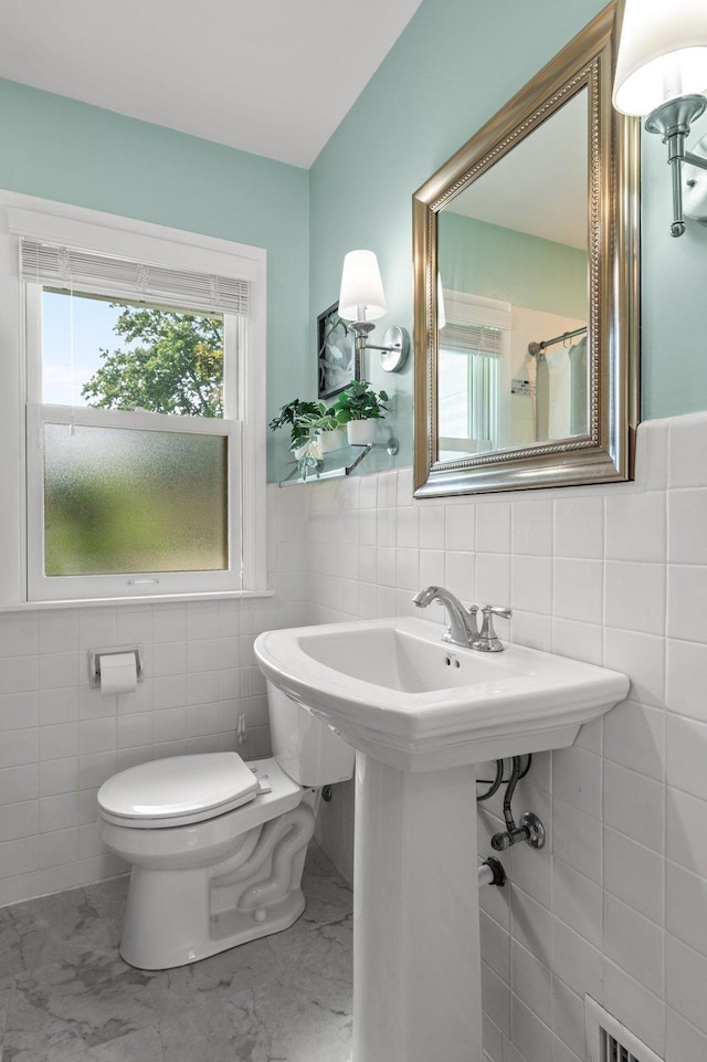 6045 Oakland Ave, Minneapolis, MN 55417 - bathroom with tile walls and marble finish floors