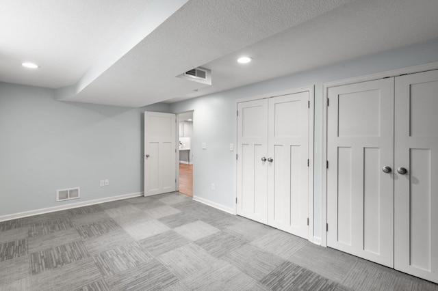 6045 Oakland Ave, Minneapolis, MN 55417 - unfurnished bedroom featuring multiple closets, carpet flooring, recessed lighting, and a textured ceiling