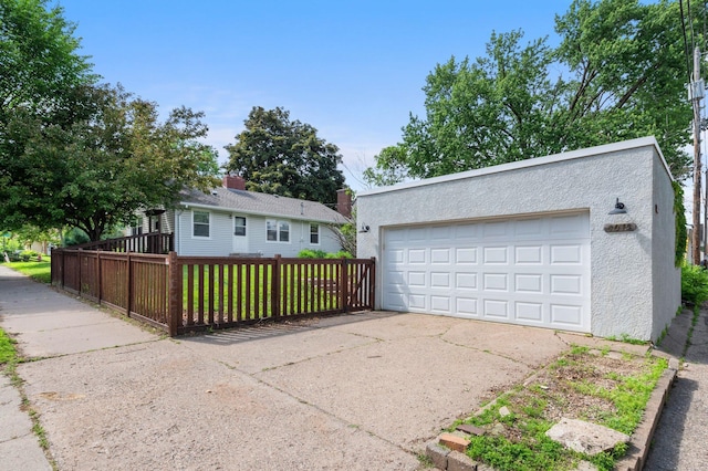 6045 Oakland Ave, Minneapolis, MN 55417 - view of front of property with a detached garage, stucco siding, and an outdoor structure