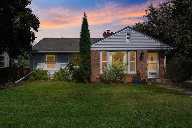 6045 Oakland Ave, Minneapolis, MN 55417 - view of front of house with a chimney, brick siding, and roof with shingles