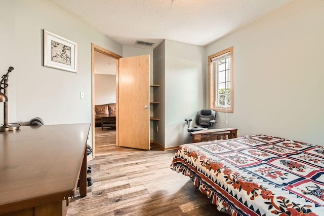 2225 Ranchview Ln N Unit 5, Plymouth, MN 55447 - bedroom with wood finished floors, an office area, and a textured ceiling