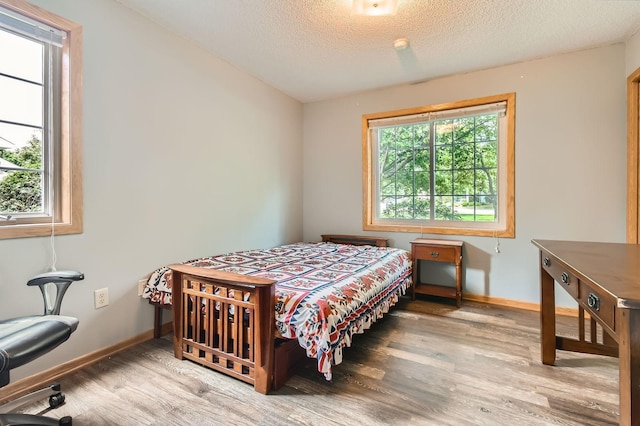 2225 Ranchview Ln N Unit 5, Plymouth, MN 55447 - bedroom with wood finished floors and a textured ceiling