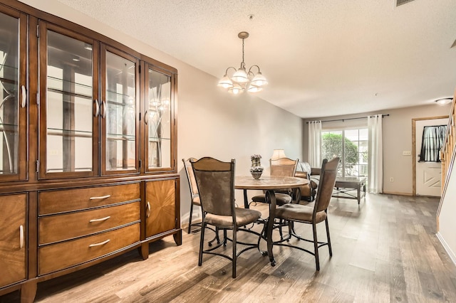 2225 Ranchview Ln N Unit 5, Plymouth, MN 55447 - dining area featuring light wood-type flooring and a chandelier