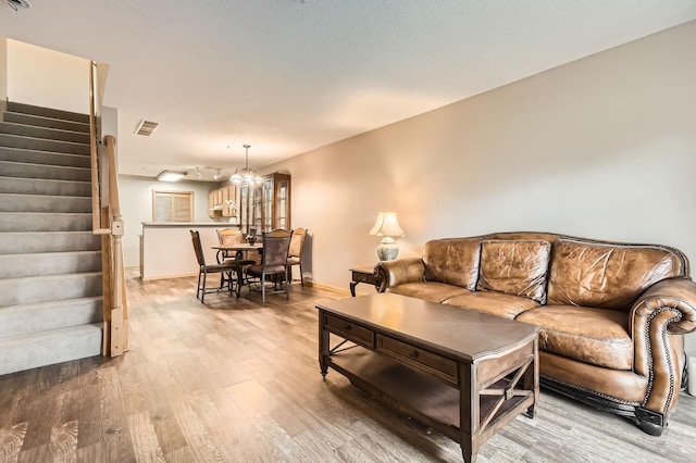 2225 Ranchview Ln N Unit 5, Plymouth, MN 55447 - living area featuring stairs, light wood-style floors, and a chandelier