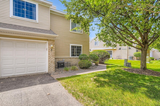 2225 Ranchview Ln N Unit 5, Plymouth, MN 55447 - view of front of property with brick siding, a front lawn, a garage, driveway, and a shingled roof