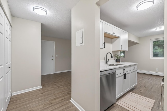 4371 Wilshire Blvd Unit 107, Mound, MN 55364 - kitchen featuring dishwasher, a baseboard heating unit, a textured ceiling, wood finished floors, and light countertops