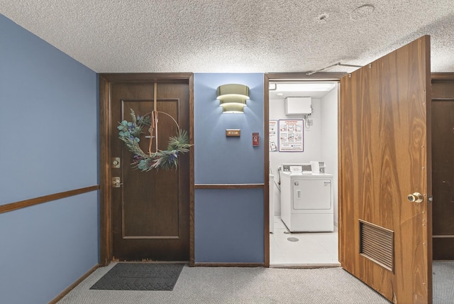 4371 Wilshire Blvd Unit 107, Mound, MN 55364 - laundry room featuring independent washer and dryer, carpet flooring, and a textured ceiling