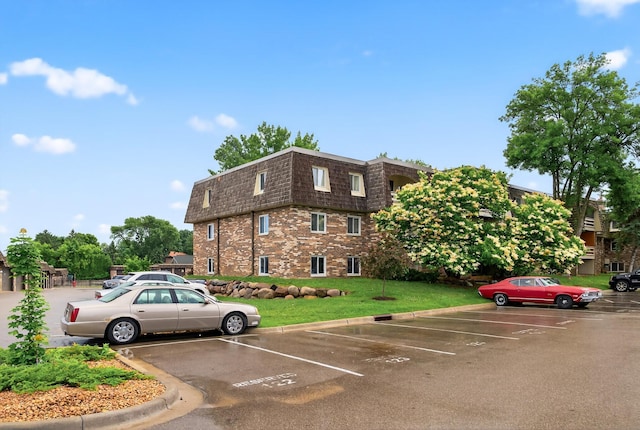 4371 Wilshire Blvd Unit 107, Mound, MN 55364 - view of property featuring uncovered parking