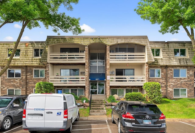 4371 Wilshire Blvd Unit 107, Mound, MN 55364 - view of property featuring uncovered parking and stairs