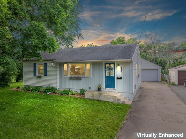 1622 3rd St NE, Rochester, MN 55906 - view of front of house featuring a garage, a yard, an outbuilding, and a shingled roof