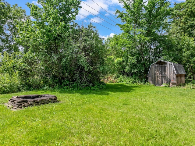 1622 3rd St NE, Rochester, MN 55906 - view of grassy yard featuring a fire pit and a storage shed