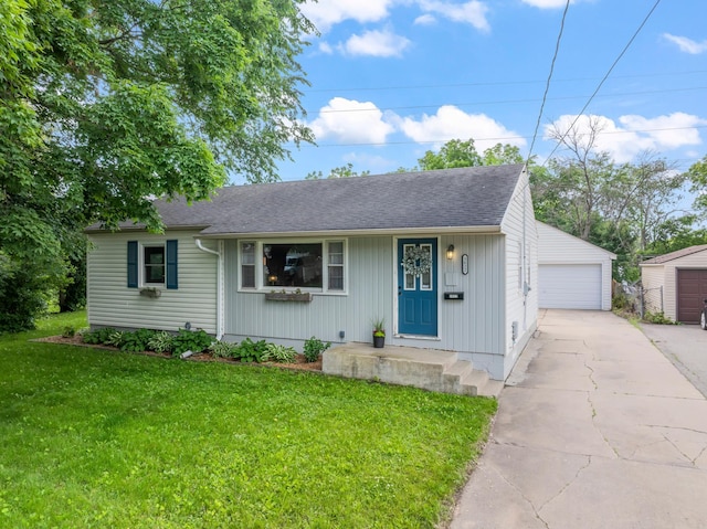 1622 3rd St NE, Rochester, MN 55906 - view of front of house featuring a detached garage, a front lawn, a shingled roof, and an outbuilding