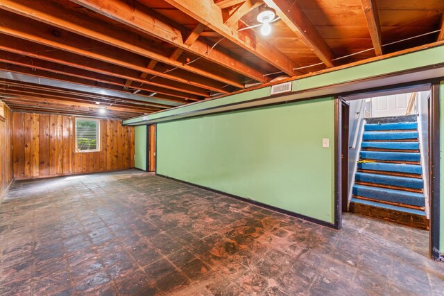 1622 3rd St NE, Rochester, MN 55906 - below grade area featuring stairs, wood walls, and tile patterned floors
