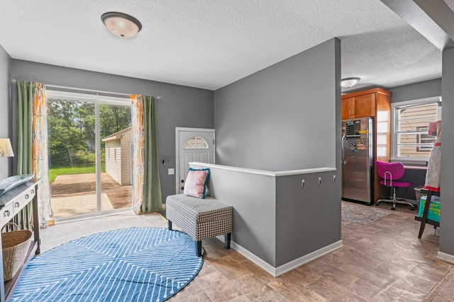 1622 3rd St NE, Rochester, MN 55906 - kitchen featuring stainless steel fridge, brown cabinets, and a textured ceiling