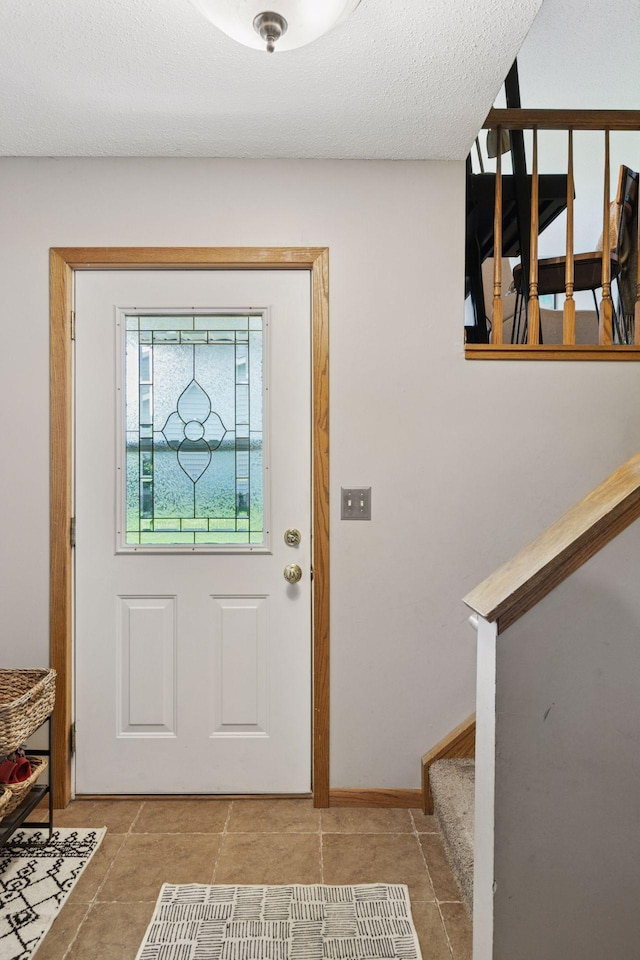 704 Lexington Ave N, New Prague, MN 56071 - tiled entryway with stairs and a textured ceiling