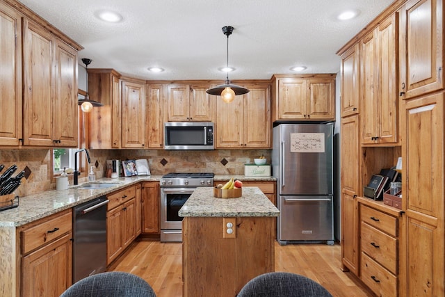 704 Lexington Ave N, New Prague, MN 56071 - kitchen featuring stainless steel appliances, light wood-style floors, light stone counters, backsplash, and recessed lighting