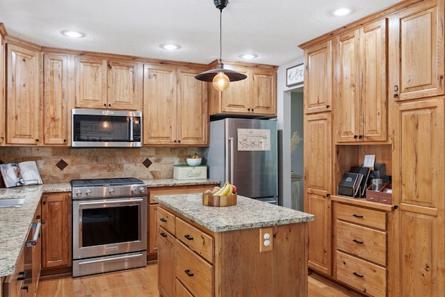704 Lexington Ave N, New Prague, MN 56071 - kitchen with stainless steel appliances, light wood-type flooring, decorative backsplash, light stone countertops, and a textured ceiling