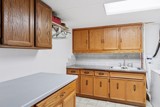 704 Lexington Ave N, New Prague, MN 56071 - kitchen featuring light countertops, backsplash, and brown cabinets