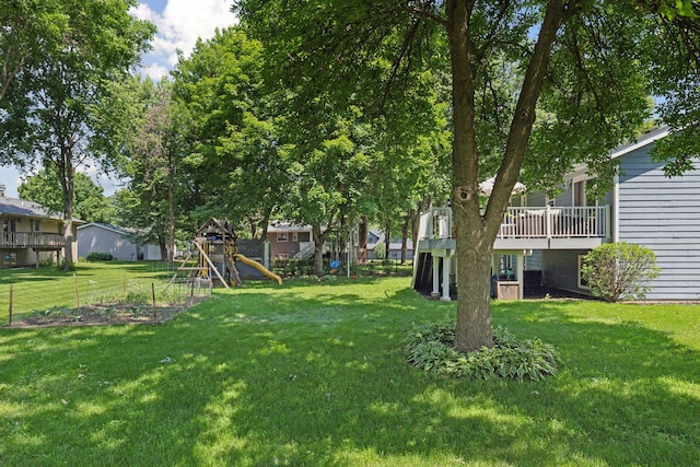 704 Lexington Ave N, New Prague, MN 56071 - view of green lawn featuring a playground, a wooden deck, a residential view, and a vegetable garden