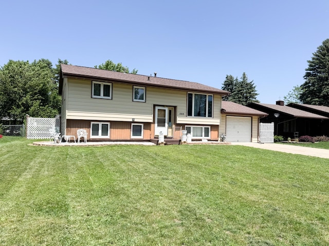 1908 Summit Ave, Worthington, MN 56187 - view of front of property with concrete driveway, a garage, and entry steps