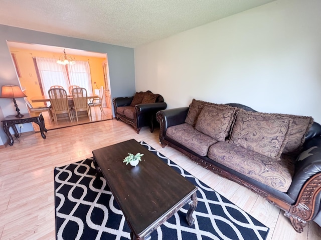 1908 Summit Ave, Worthington, MN 56187 - living room featuring a chandelier, wood finished floors, and a textured ceiling