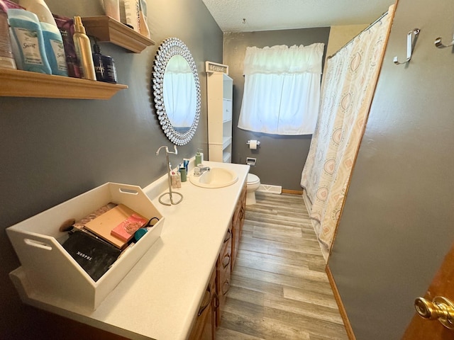 1908 Summit Ave, Worthington, MN 56187 - bathroom featuring wood finished floors, vanity, curtained shower, and a textured ceiling