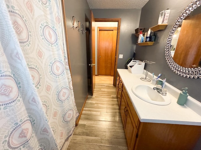1908 Summit Ave, Worthington, MN 56187 - full bathroom with wood finished floors, vanity, and a textured ceiling