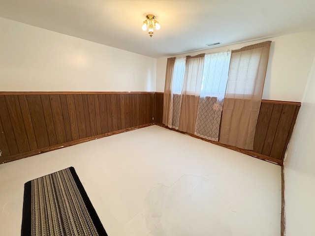 1908 Summit Ave, Worthington, MN 56187 - spare room with wood walls and a wainscoted wall