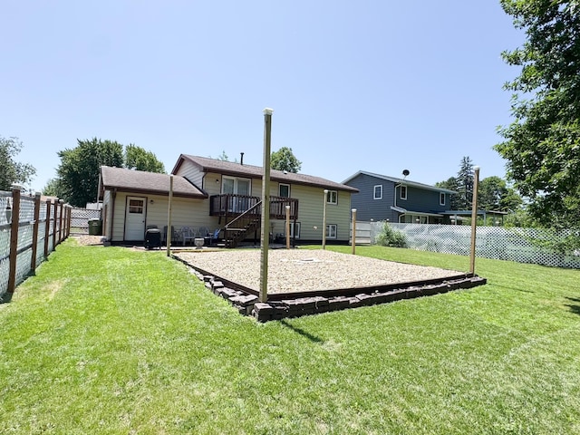 1908 Summit Ave, Worthington, MN 56187 - back of property featuring a fenced backyard, a wooden deck, and stairway