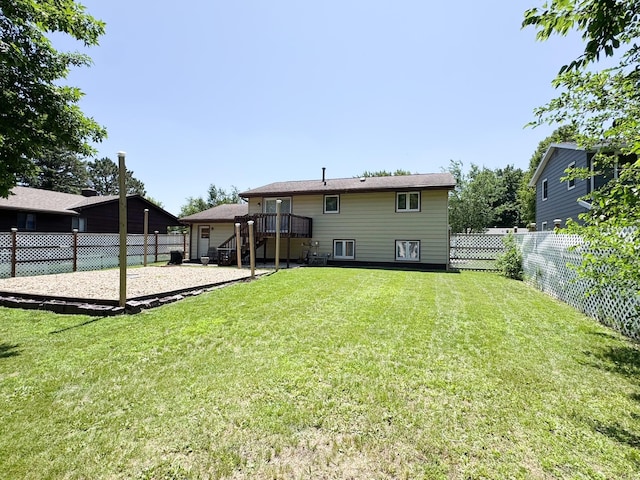 1908 Summit Ave, Worthington, MN 56187 - back of house featuring a fenced backyard, a wooden deck, and stairs