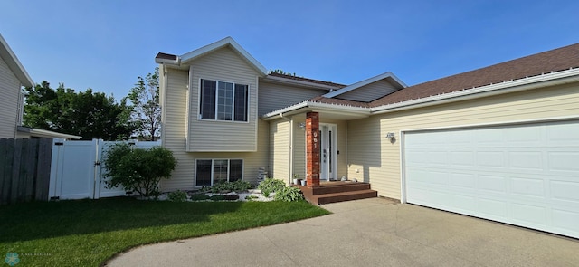 961 39 1/2 Ave W, West Fargo, ND 58078 - split level home featuring driveway, a garage, and a gate