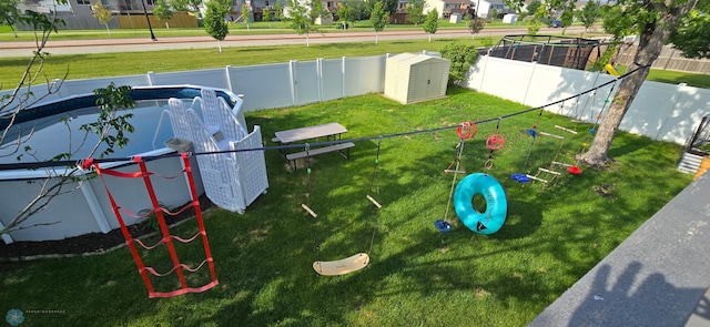 961 39 1/2 Ave W, West Fargo, ND 58078 - surrounding community with a storage shed, a dog friendly area, a fenced backyard, and a residential view