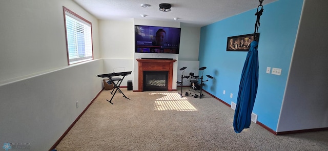 961 39 1/2 Ave W, West Fargo, ND 58078 - workout area featuring carpet floors, a fireplace, and a textured ceiling