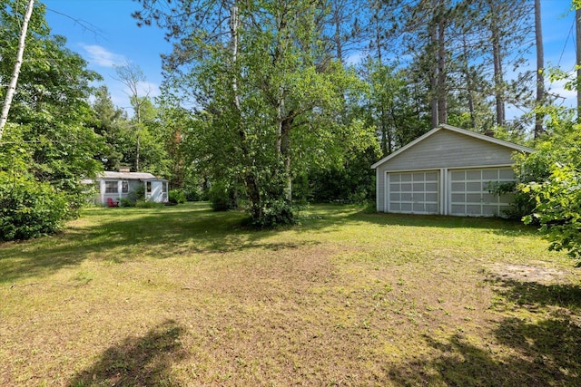 31905 Jefferson Blvd, Greenway Twp, MN 55775 - view of green lawn with an outdoor structure and a garage