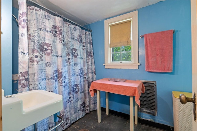 31905 Jefferson Blvd, Greenway Twp, MN 55775 - bathroom featuring heating unit, concrete flooring, and curtained shower