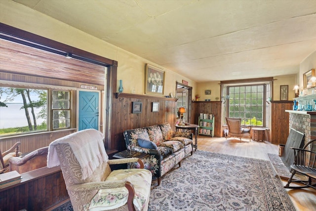31905 Jefferson Blvd, Greenway Twp, MN 55775 - living room featuring wood finished floors, wood walls, wainscoting, and a fireplace