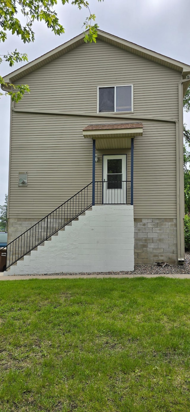 5293 Manchester Dr Unit 1, Maple Plain, MN 55359 - rear view of property featuring a lawn and stairway