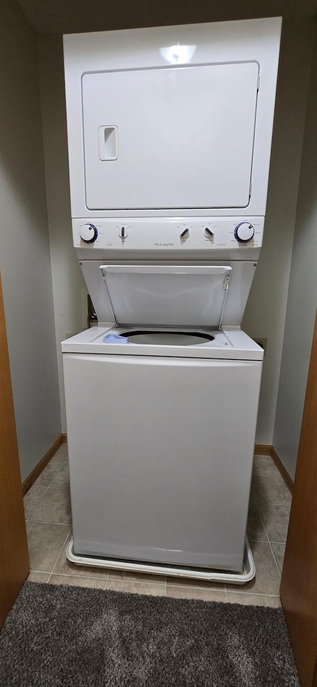 5293 Manchester Dr Unit 1, Maple Plain, MN 55359 - laundry room with stacked washer / drying machine and light tile patterned floors