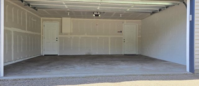5293 Manchester Dr Unit 1, Maple Plain, MN 55359 - garage with a garage door opener and concrete block wall