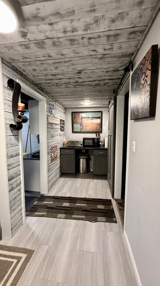 306 4th St, La Crescent, MN 55947 - corridor featuring a barn door and light wood-style flooring