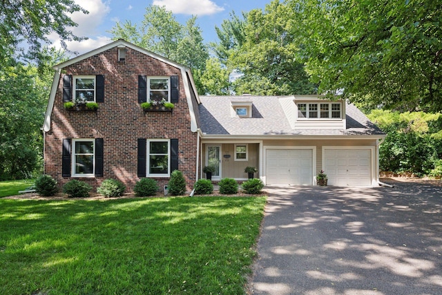 10301 Brunswick Cir, Bloomington, MN 55438 - view of front of home featuring driveway, a front lawn, brick siding, an attached garage, and a shingled roof