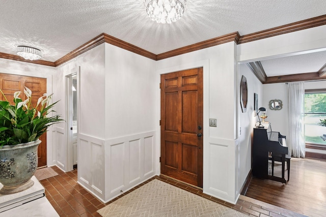 10301 Brunswick Cir, Bloomington, MN 55438 - foyer entrance featuring a textured ceiling, crown molding, a chandelier, a decorative wall, and a wainscoted wall