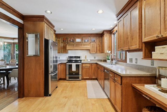10301 Brunswick Cir, Bloomington, MN 55438 - kitchen with appliances with stainless steel finishes, brown cabinets, light wood-type flooring, recessed lighting, and light countertops