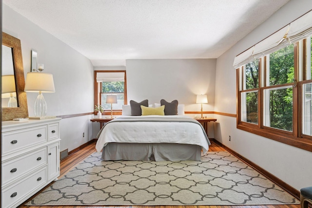 10301 Brunswick Cir, Bloomington, MN 55438 - bedroom featuring light wood-style flooring and a textured ceiling