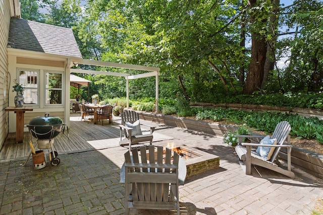 10301 Brunswick Cir, Bloomington, MN 55438 - view of patio / terrace with an outdoor fire pit, outdoor dining space, a deck, and area for grilling