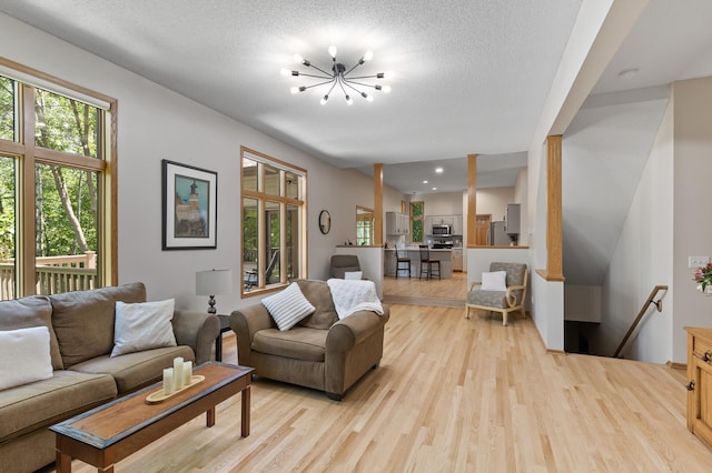 13756 Skyline Cir, Louisville Twp, MN 55379 - living room featuring light wood finished floors and a chandelier