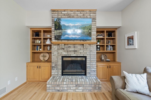 13756 Skyline Cir, Louisville Twp, MN 55379 - living room with light wood-style flooring and a brick fireplace