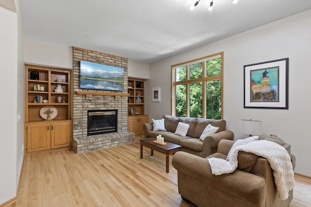 13756 Skyline Cir, Louisville Twp, MN 55379 - living area featuring light wood finished floors, a fireplace, and a textured ceiling