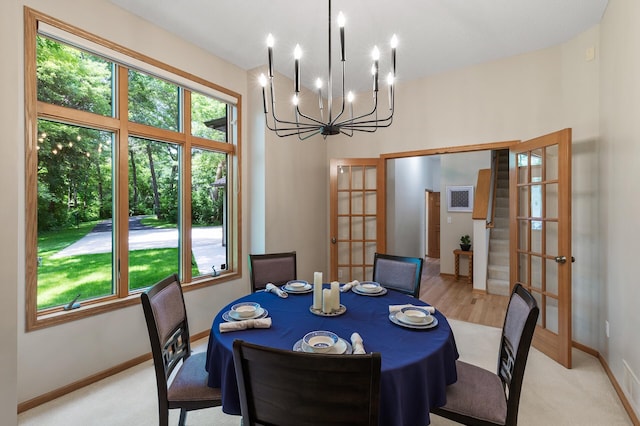 13756 Skyline Cir, Louisville Twp, MN 55379 - dining area featuring french doors, a chandelier, and light carpet
