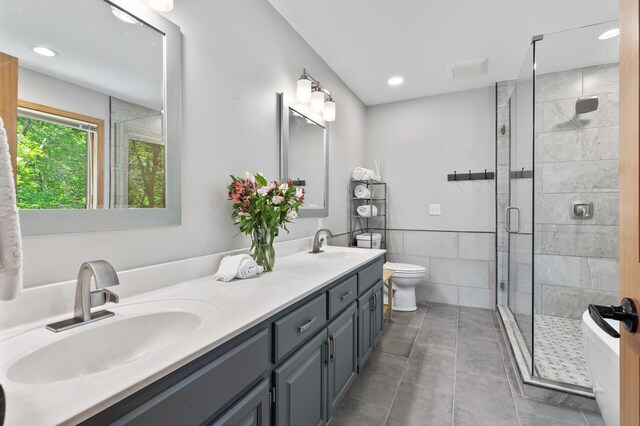 13756 Skyline Cir, Louisville Twp, MN 55379 - bathroom featuring double vanity, a shower stall, recessed lighting, tile patterned floors, and tile walls